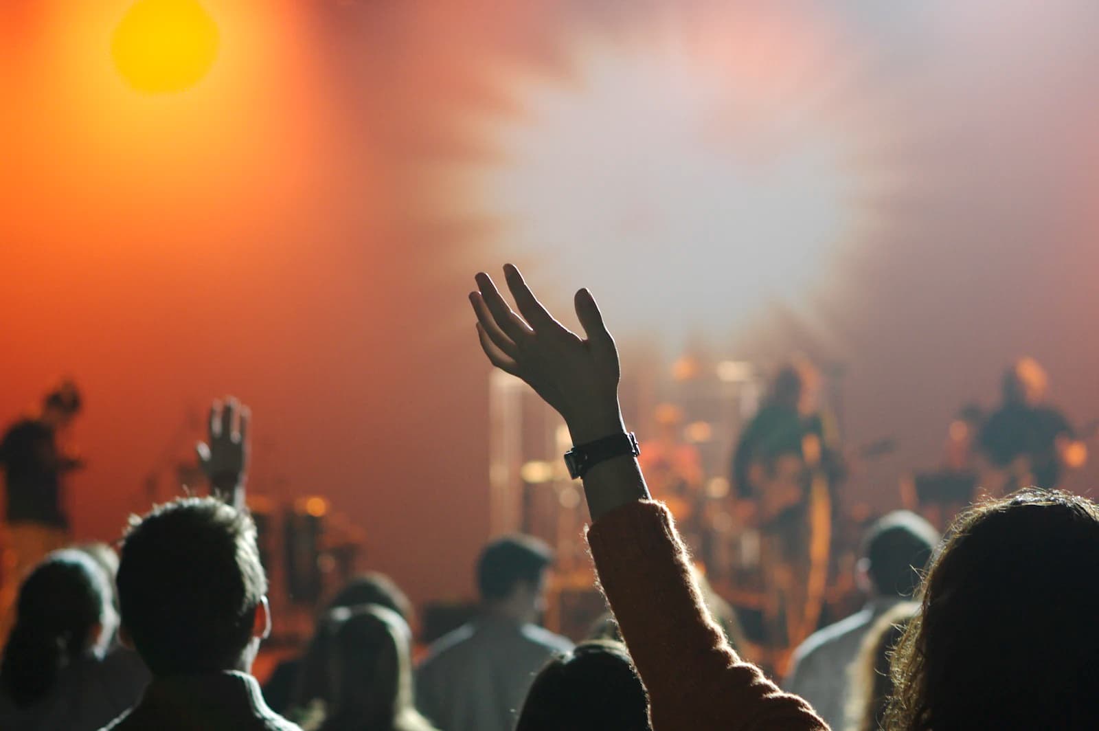 A congregation worshipping with hands raised